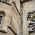 The facade of the Royal Courts of Justice in London, England showing the coat of arms of the courts and architectural details