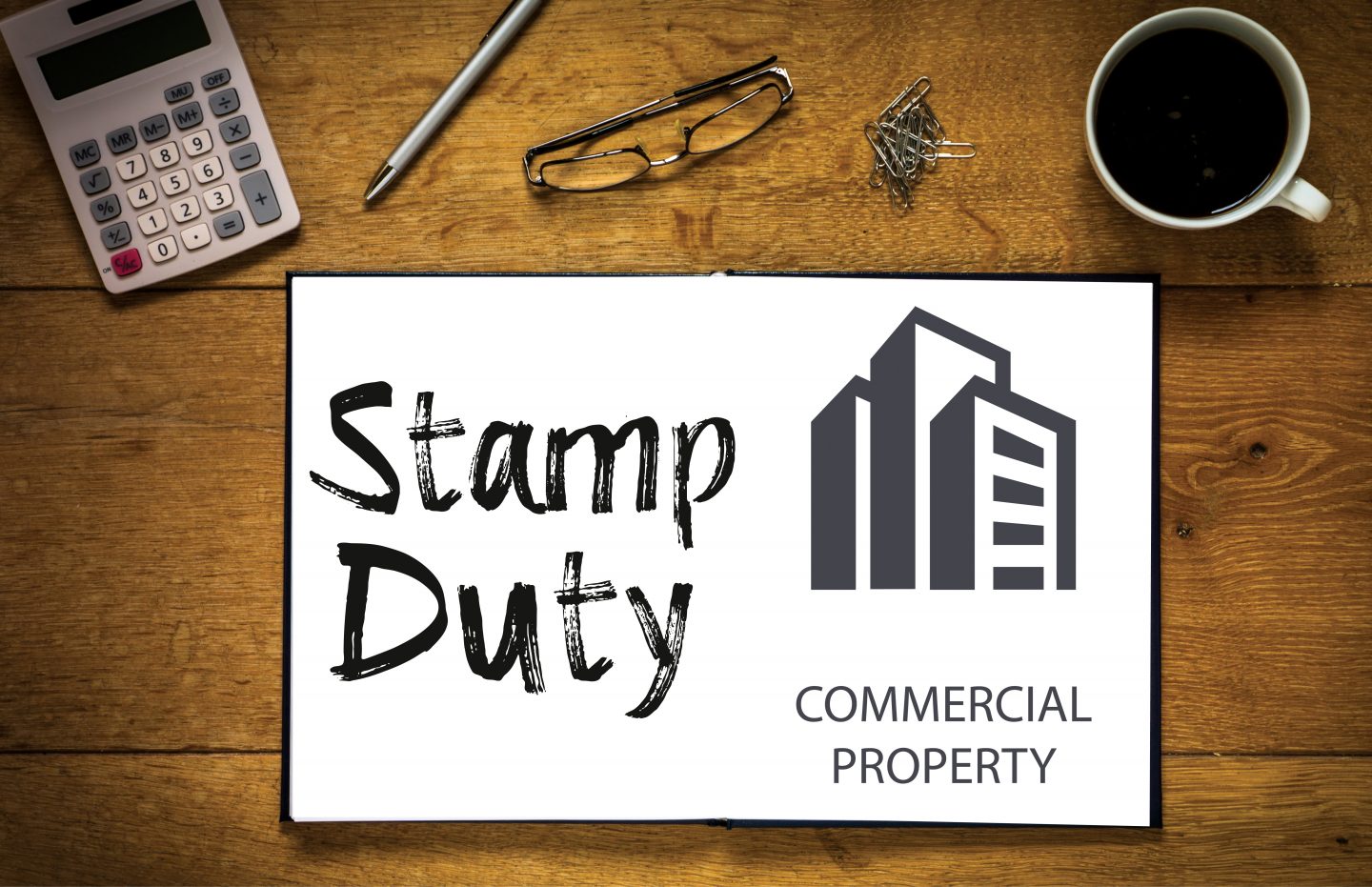 Overhead top view of Stamp Duty written in book on desk with a c